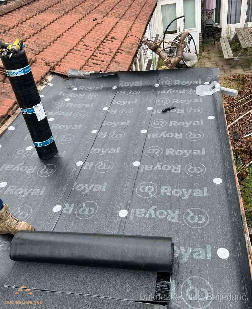 Plat dak met nieuwe bitumen dakbedekking en brandgereedschap in Oud-Beijerland
